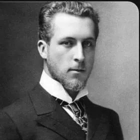 Black-and-white portrait of a young man in formal attire with a high-collared shirt and neatly styled hair.